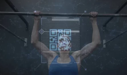 Pulling fit woman in blue sleeveless top gripping metal pull-up bar at gym, showing QR-code overlay